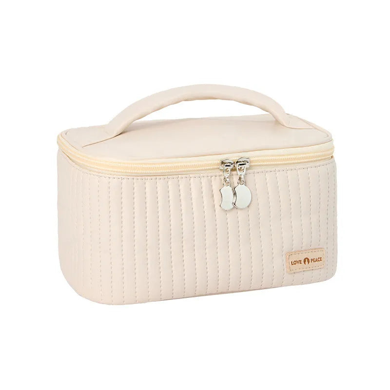 Open-top pastel pink PU leather makeup bag with a flat base, showing interior space.