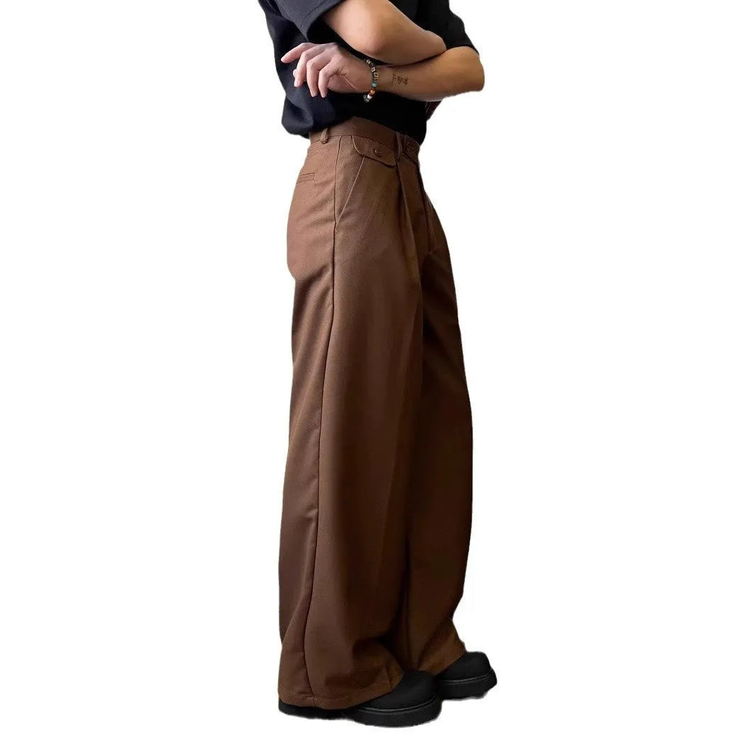 Man wearing straight-leg wide-leg casual trousers in brown, showcasing the relaxed drape and fit.