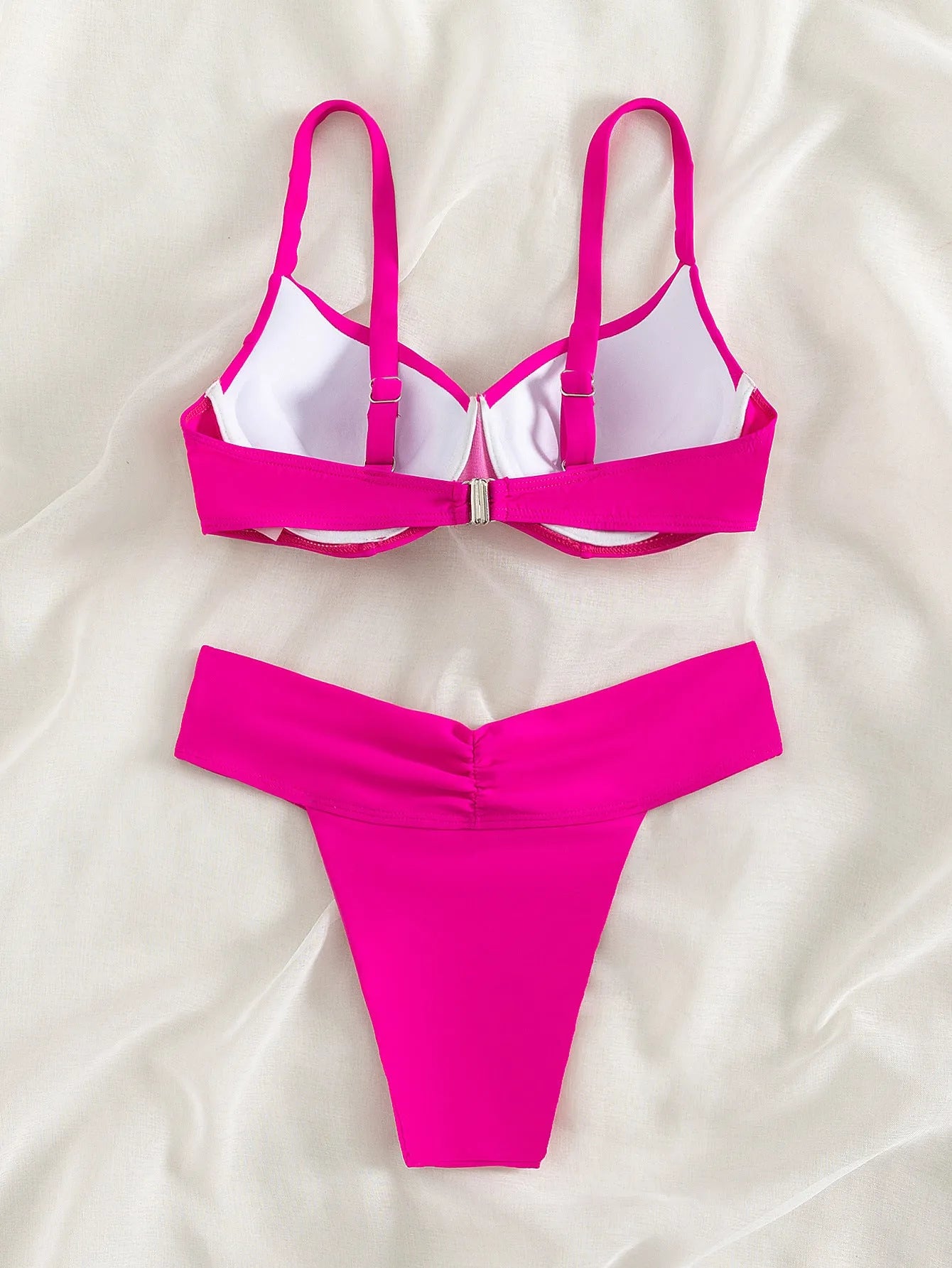 Women's solid colour split bikini swimsuit in fluorescent pink on a mannequin.