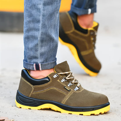 Bronze cow suede low-cut safety shoes with steel toe cap and patterned rubber sole on a workbench.