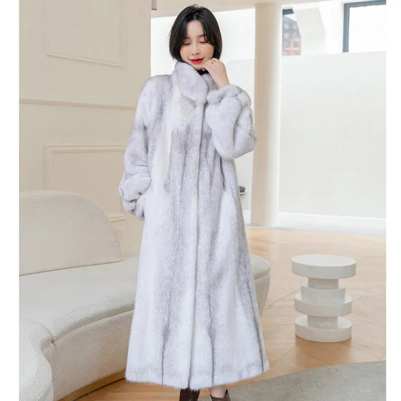 White faux fur women's winter coat with stand-up collar on a hanger