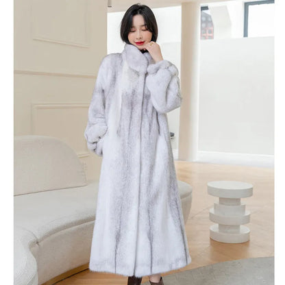 White faux fur women's winter coat with stand-up collar on a hanger