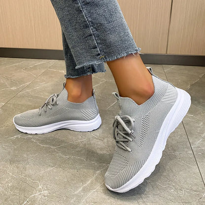 Women's Flyknit mesh running shoes in milky white with a low flat heel and rubber sole