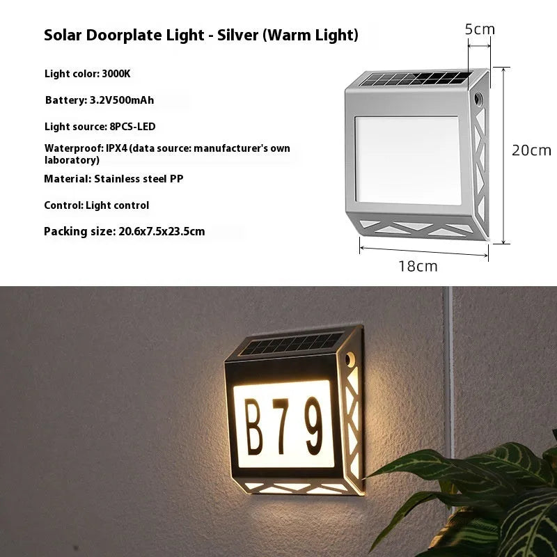 Black solar doorplate light with LED illumination showing house numbers