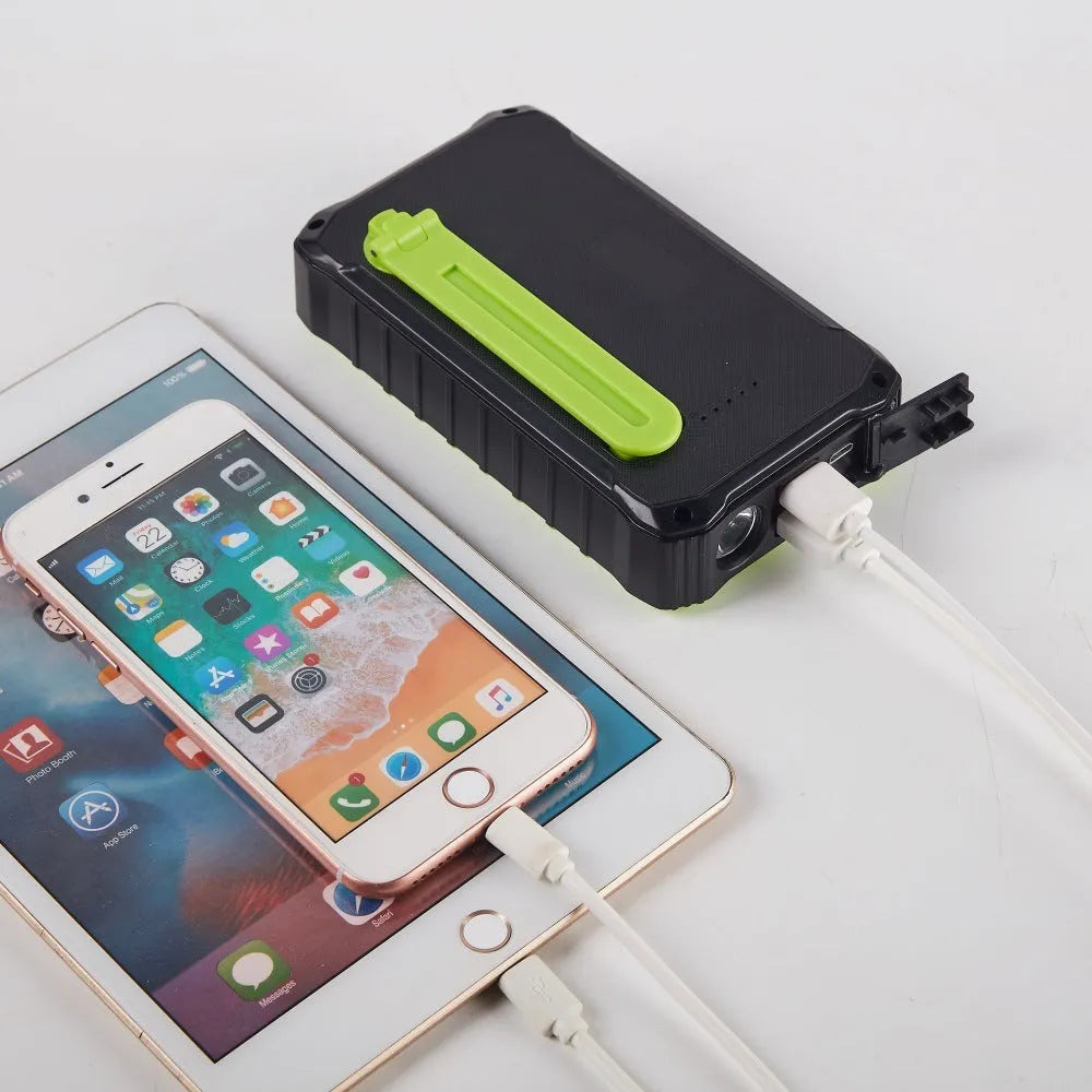 Orange and green portable solar power bank with hand crank, solar panel, and dual USB ports