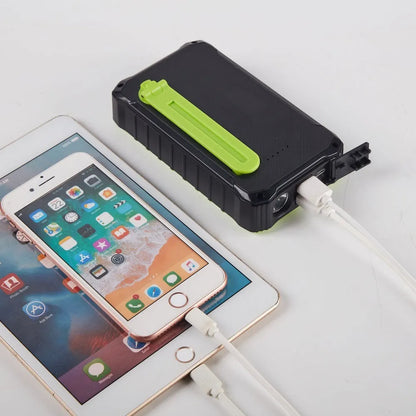 Orange and green portable solar power bank with hand crank, solar panel, and dual USB ports