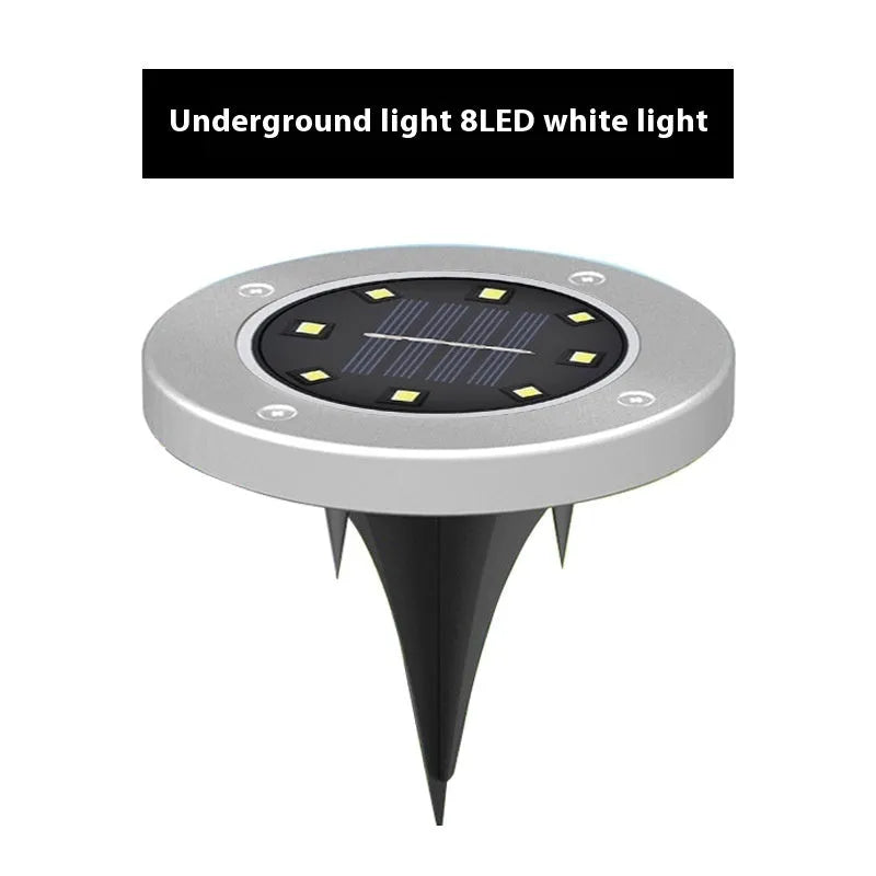 Stainless steel solar garden ground lamp installed in a lawn.