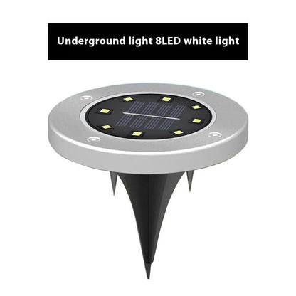 Stainless steel solar garden ground lamp installed in a lawn.