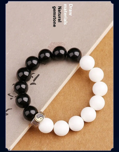 Black and white Tai Chi bracelet with obsidian beads and six-word mantra in geometric pattern