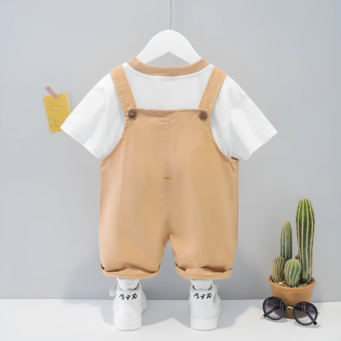 Yellow cotton baby cartoon romper suit with short sleeves and openable straps