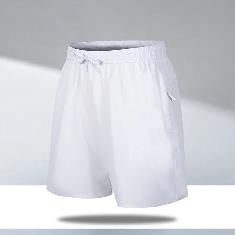 Man wearing black loose-fit quick-dry polyester sports shorts on a summer day.