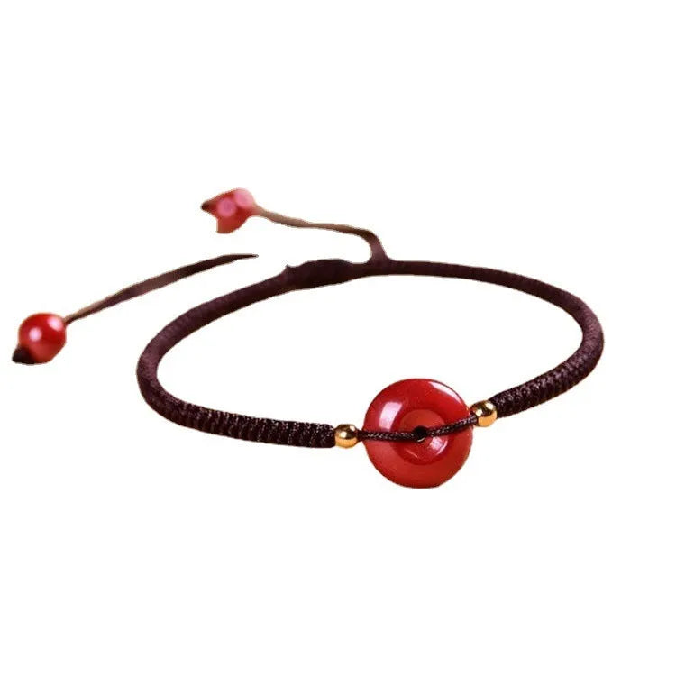 Cinnabar heart-shaped bracelet with safety buckle closure and adjustable coloured rope in traditional Chinese design