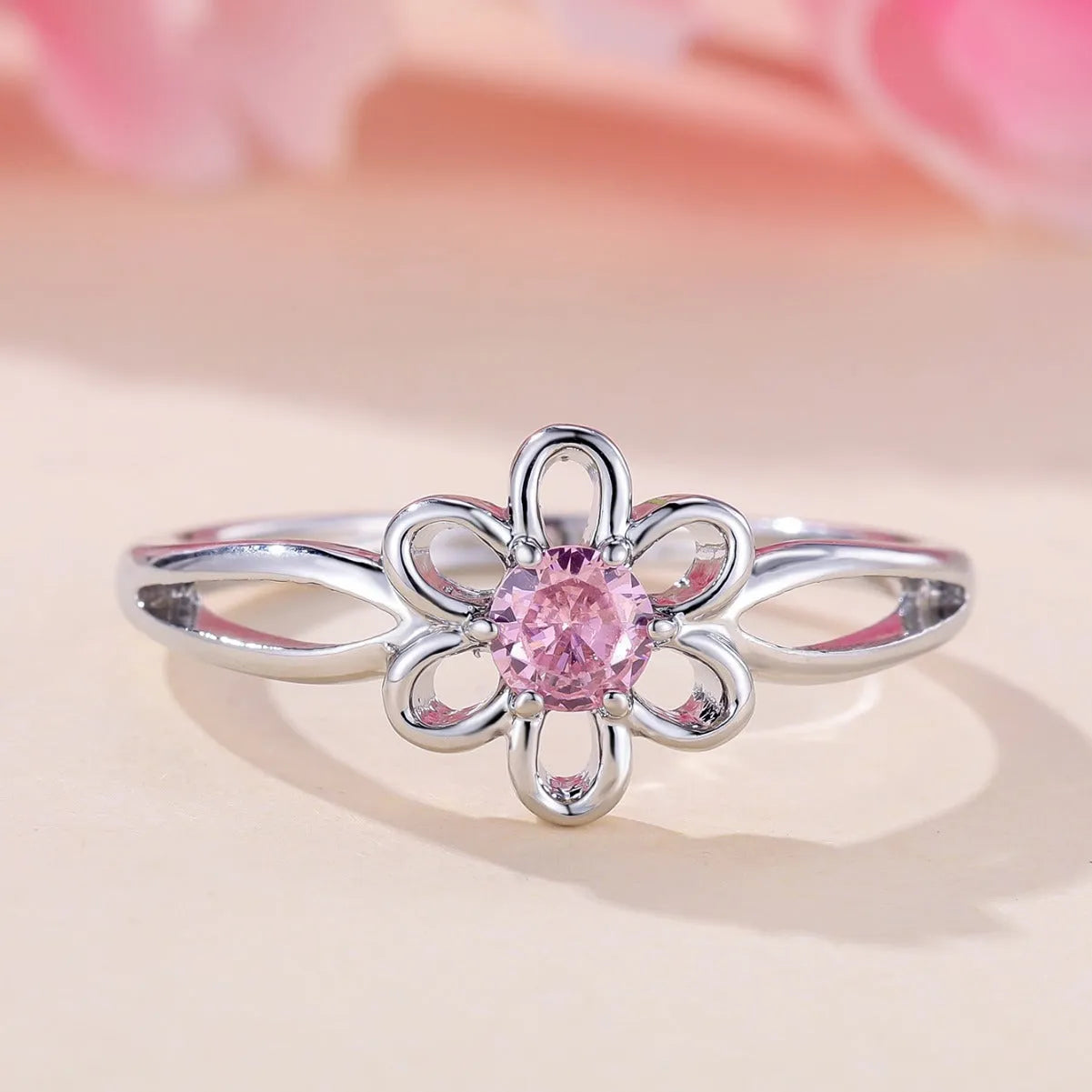 Women's flower hollow ring in pink diamond colour with floral design on copper band