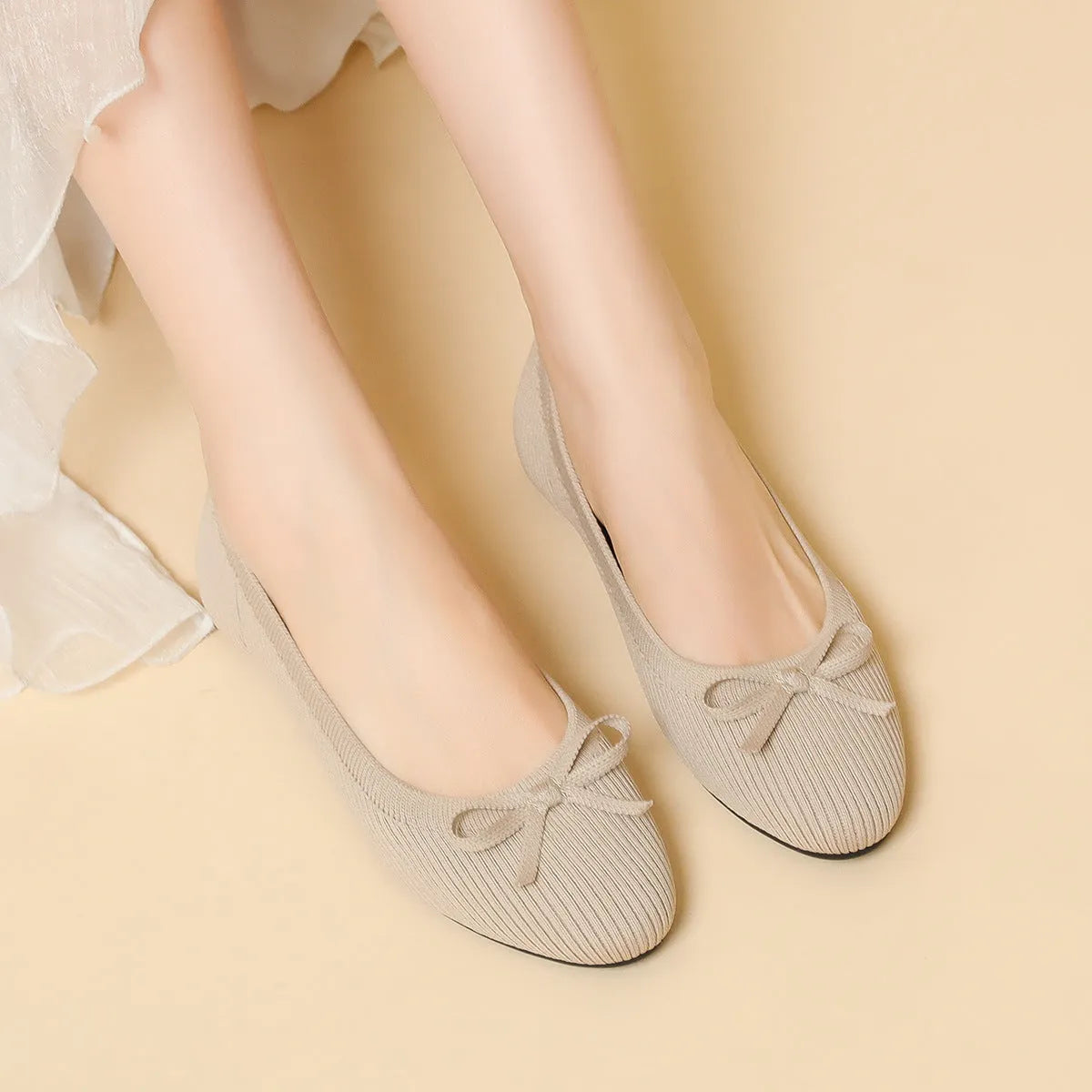 Women's round toe flat pumps with bow detail in butterfly colours showing fabric upper and shallow mouth opening