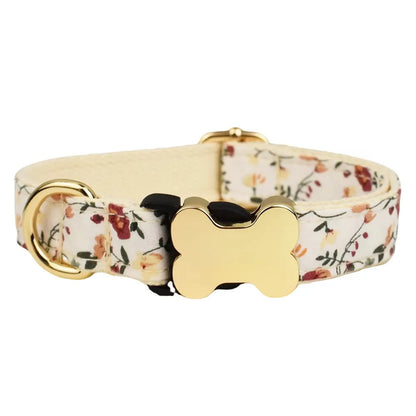 Flat nylon grid print dog collar with a white plastic bone-shaped buckle on a green background.