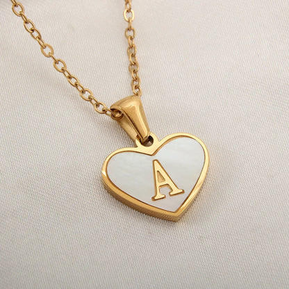 Gold-plated heart necklace with white shell pendant showing letter personalisation option
