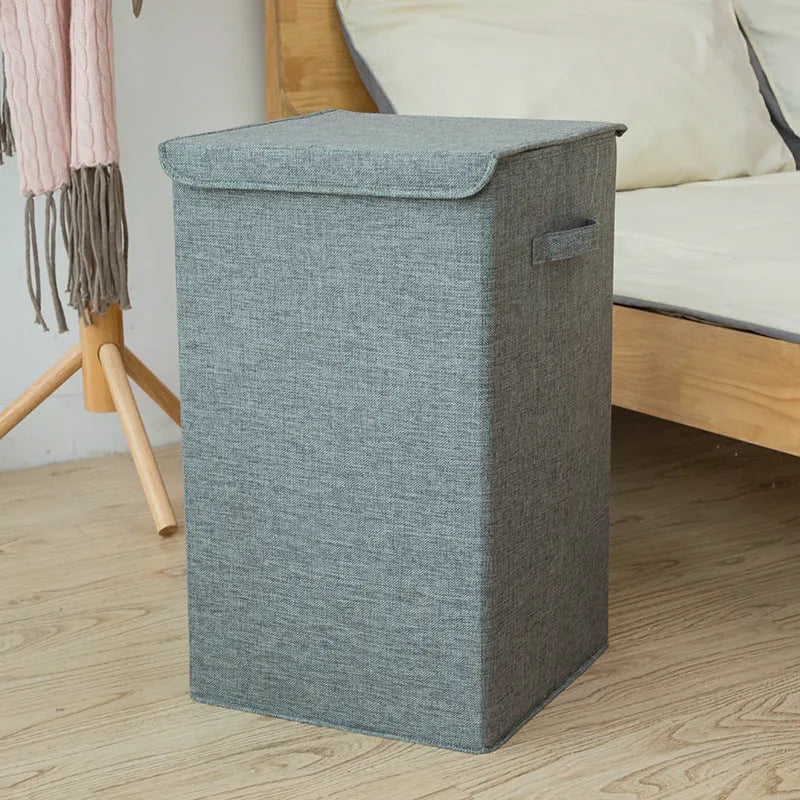 Foldable cube-shaped laundry basket in cotton linen fabric, shown in brown colour.