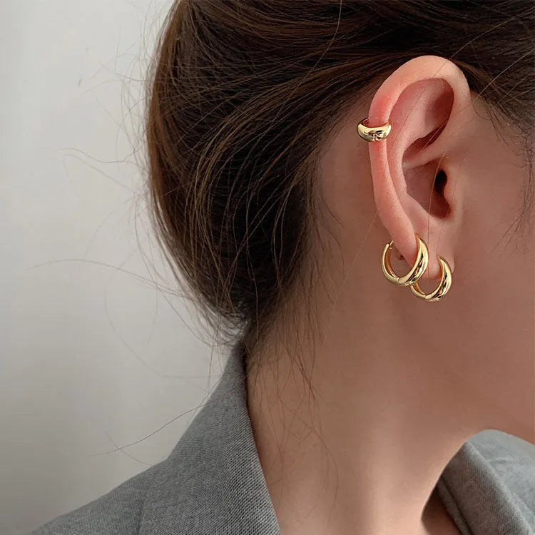 Women's minimalist geometric water drop earrings in gold and silver, shown in large, medium, and small sizes.