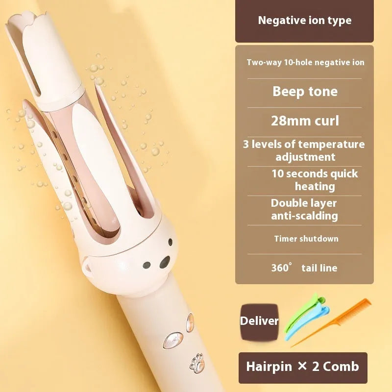 Beige automatic hair curler machine with negative ion technology and included styling stick on a table.