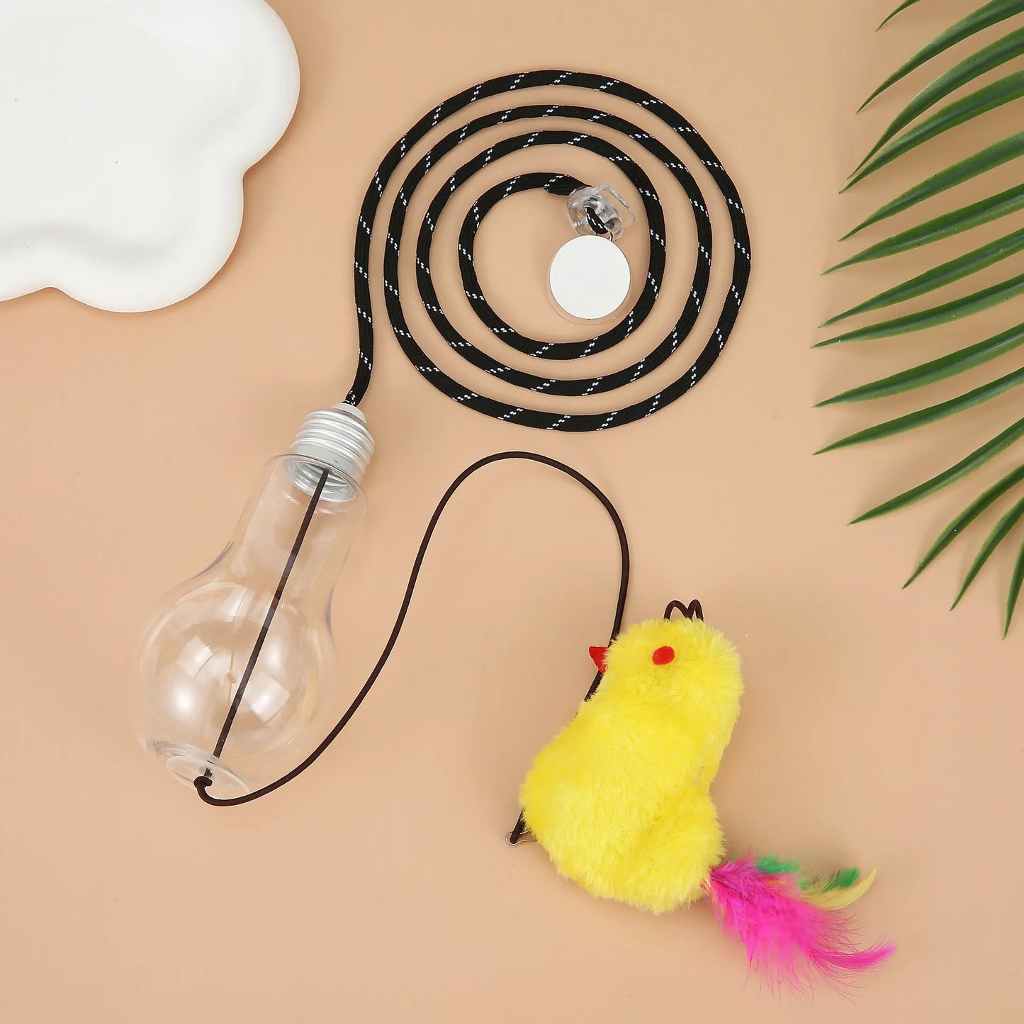Interactive cat toy hanging from door frame with elastic rope, sound response system, and treat reward dispenser
