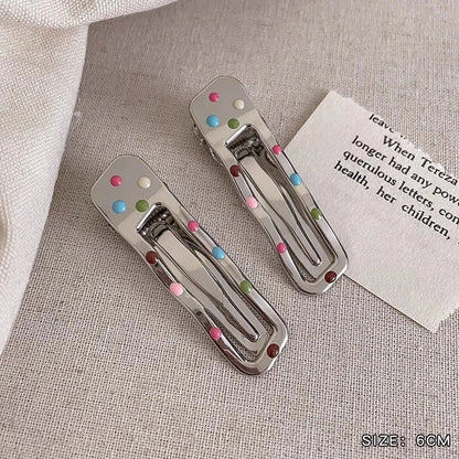 Silver metal hair barrettes with hollow heart pattern and duckbill clip design