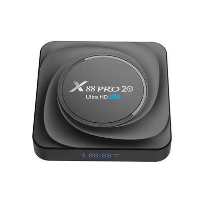 Compact black Android TV set-top box with HDMI port, remote control, and power cable.