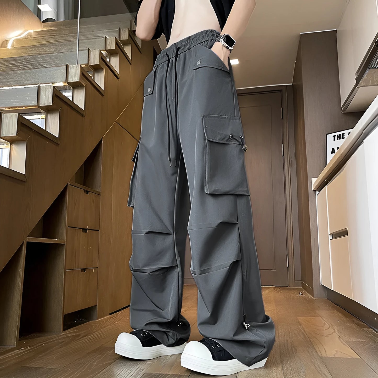 Plus size thin waterproof trousers in a loose straight-leg style on a hanger.