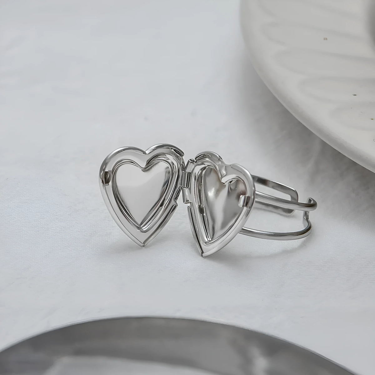 Stainless steel love heart-shaped ring for women with electroplated finish, shown as a single ring
