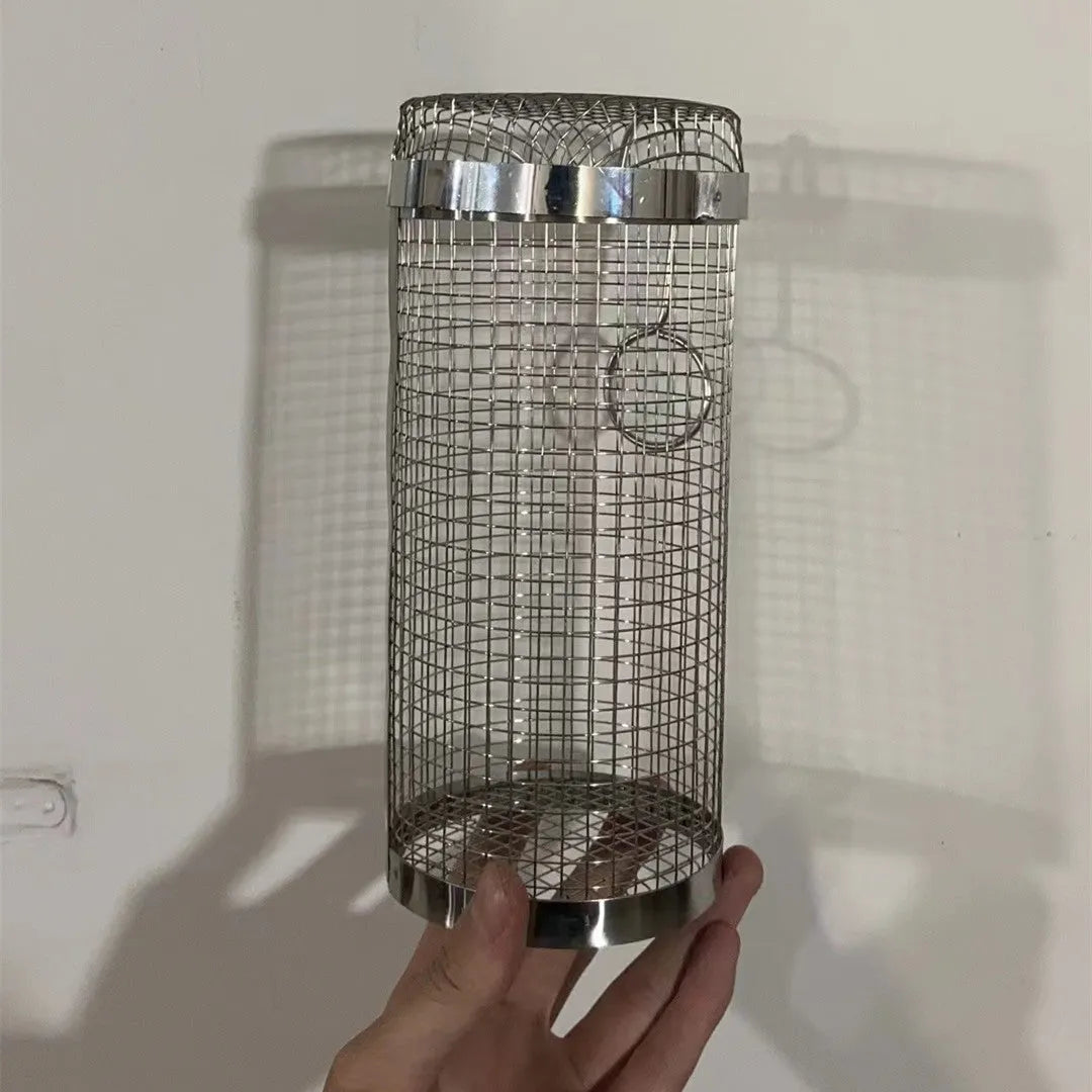 Silver iron wire rolling cylinder BBQ basket with mesh design and a hook for grilling.