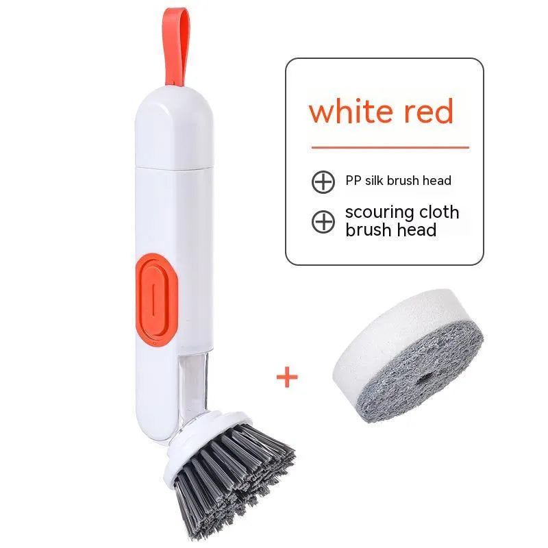 White and red long-handle kitchen brush with soap dispenser button and two interchangeable scrub heads on a hook.