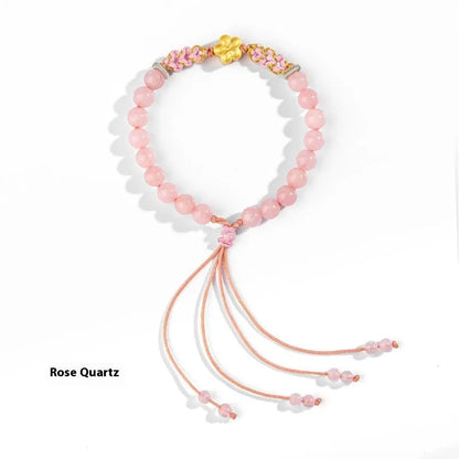 Hand-woven red rope bracelet with crystal peach blossom charm in Chinese style