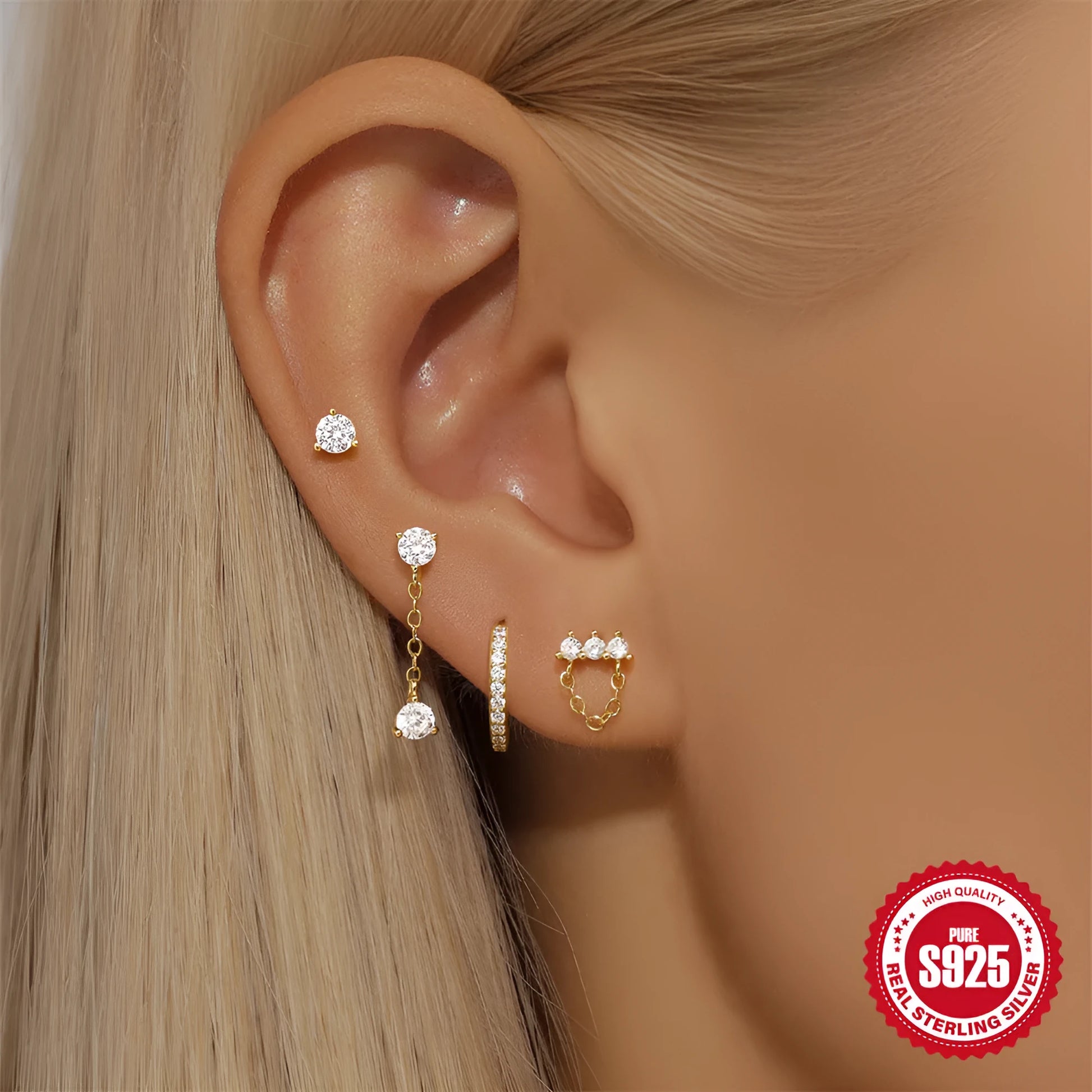 A pair of geometric clover petal earrings in sterling silver with an electroplated gold finish, shown against a neutral background.