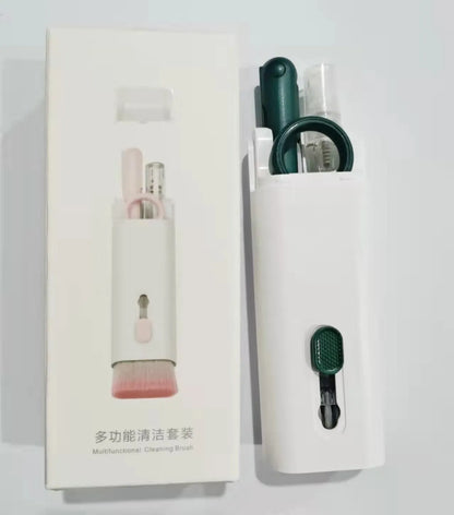 White electronics cleaning kit with a cleaning pen, spray bottle, brush, and keycap puller on a table