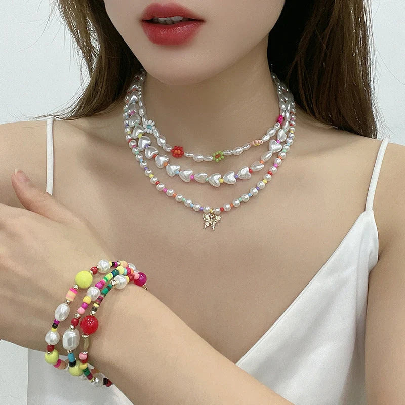 Elegant gold-plated necklace set featuring multi-row imitation pearl design, perfect for formal and casual wear
