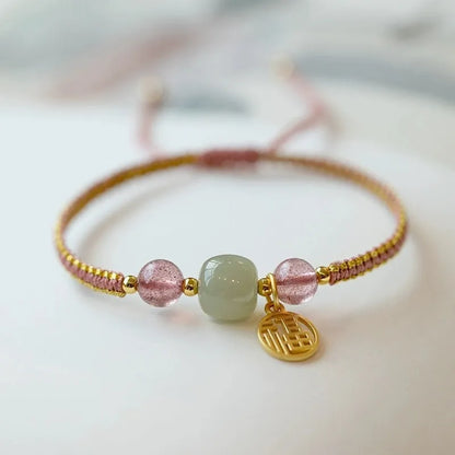 Adjustable red rope bracelet with transfer beads in Strawberry Quartz style on a wrist.