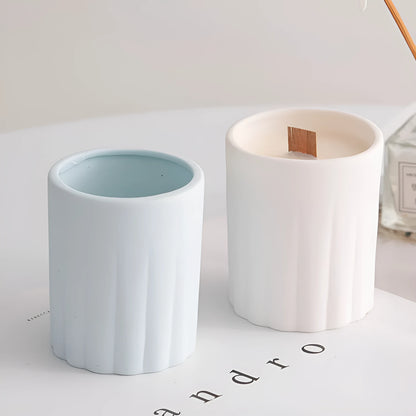 Set of ten round white ceramic candlesticks with minimalist relief patterns on a dining table