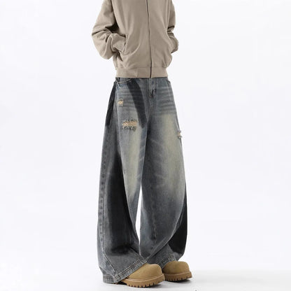 Men's blue ripped jeans with splash-ink distressing and loose fit