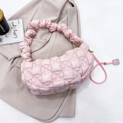 Women's light grey nylon underarm messenger bag with adjustable long strap, shown worn crossbody.
