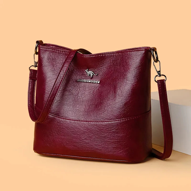 Women's soft leather bucket shoulder bag in black, wine red, or ginger yellow with large capacity and minimalist design
