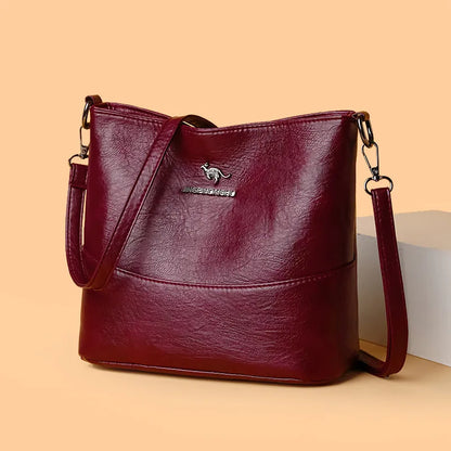 Women's soft leather bucket shoulder bag in black, wine red, or ginger yellow with large capacity and minimalist design
