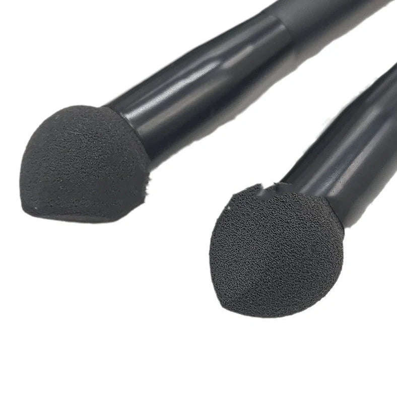 Black sponge stick concealer brush with wooden handle and tapered tip for dark circle coverage