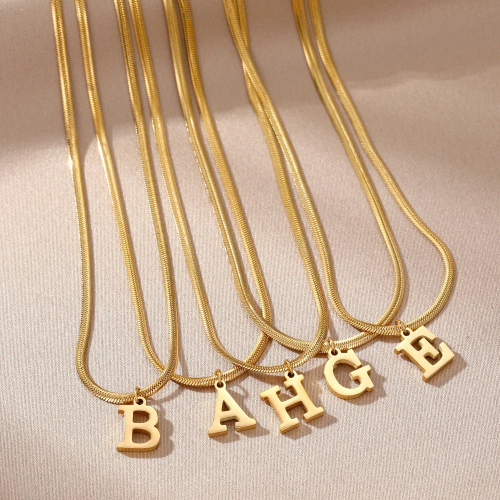 Elegant gold A-Z letter pendant necklace on a snake chain