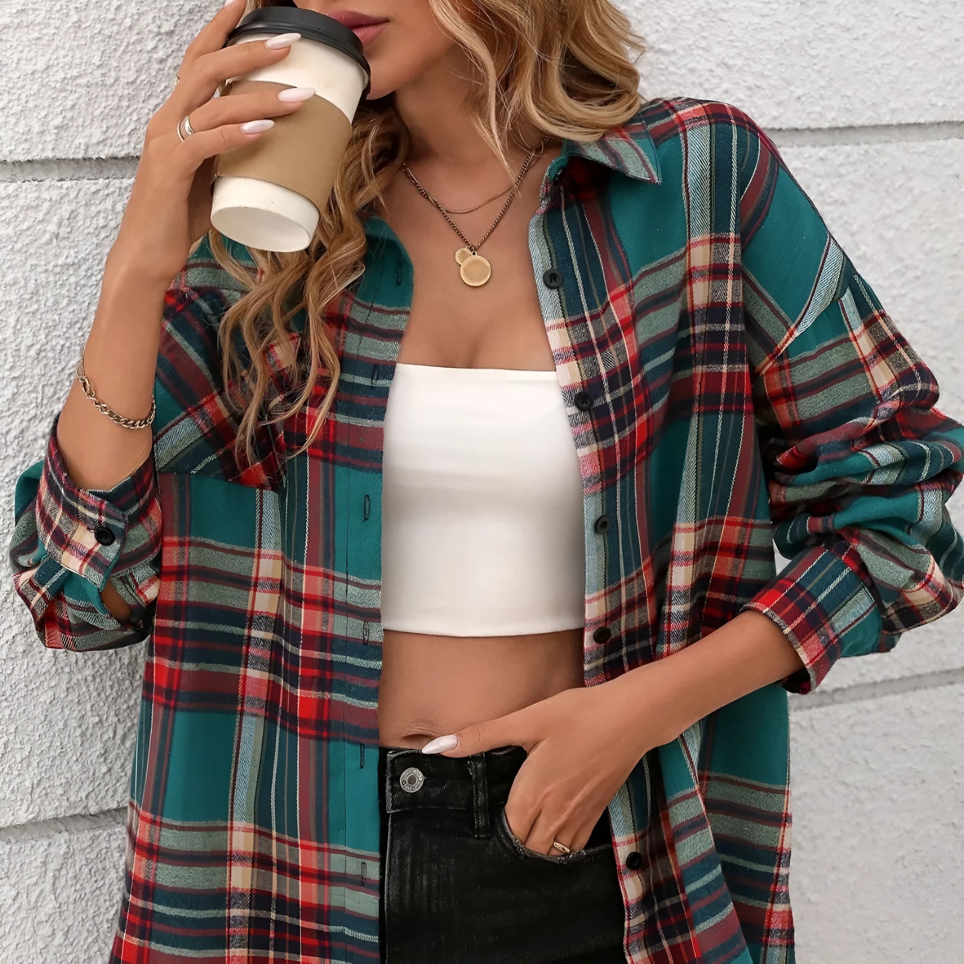 Woman wearing a loose-fit black and white plaid long sleeve shirt made from 100% cotton.