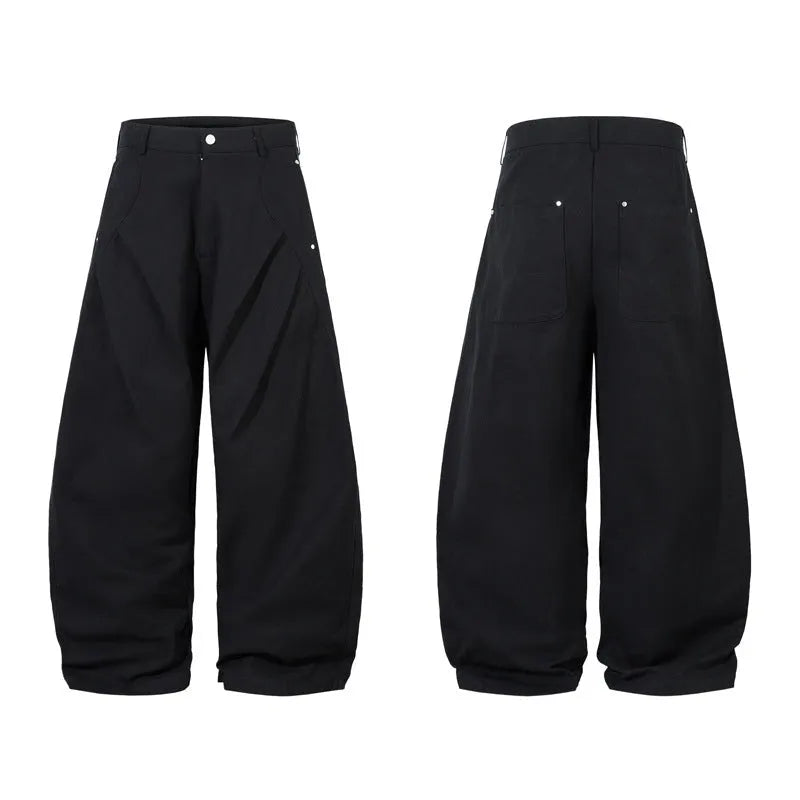 Men's black cotton pleated casual trousers with a loose-fitting wide-leg silhouette.
