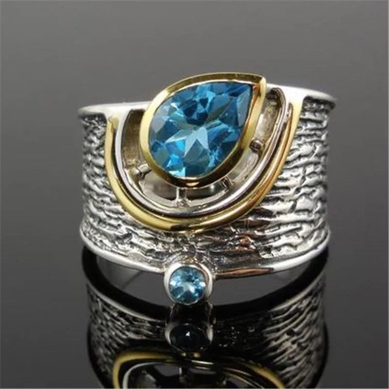 Creative Chinese style women's ring with an inlaid blue zircon stone in a drop shape on an alloy band.