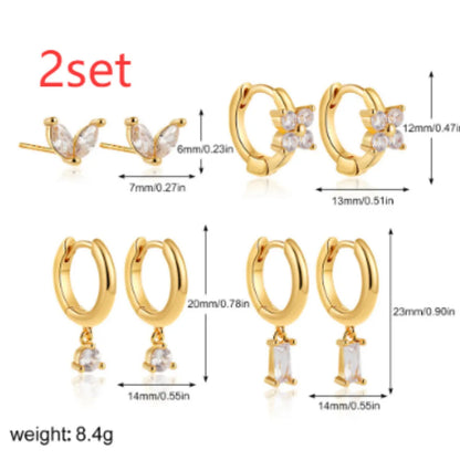 Set of four pairs of geometric copper earrings with zircon stones in gold or silver electroplated finish.
