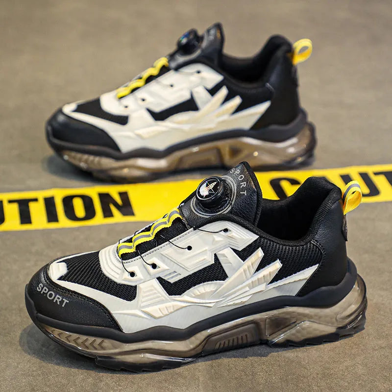 Men's black casual shoes with a rotating button fastener and mesh upper on a low platform sole
