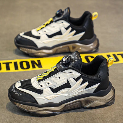 Men's black casual shoes with a rotating button fastener and mesh upper on a low platform sole