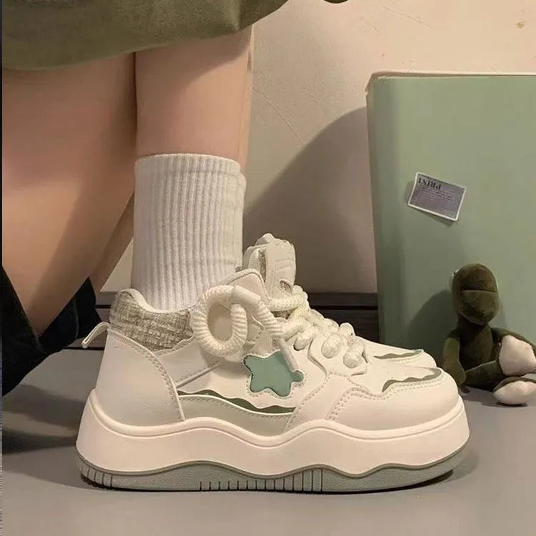 Women's green patent leather platform sneaker with round toe and lace-up closure on a rubber sole