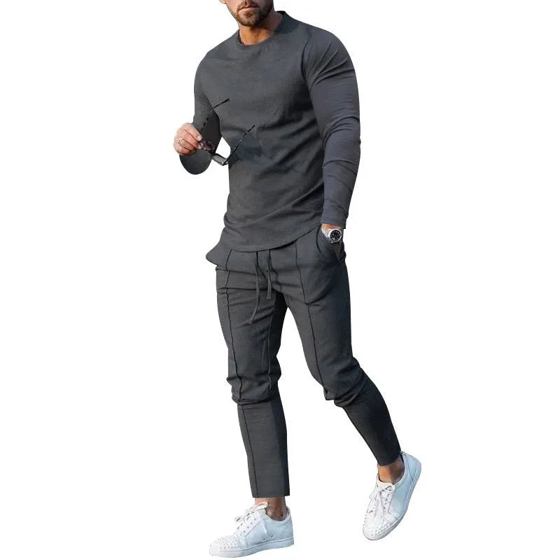 Men's solid colour two-piece lounge suit with long sleeve T-shirt and trousers in light grey.